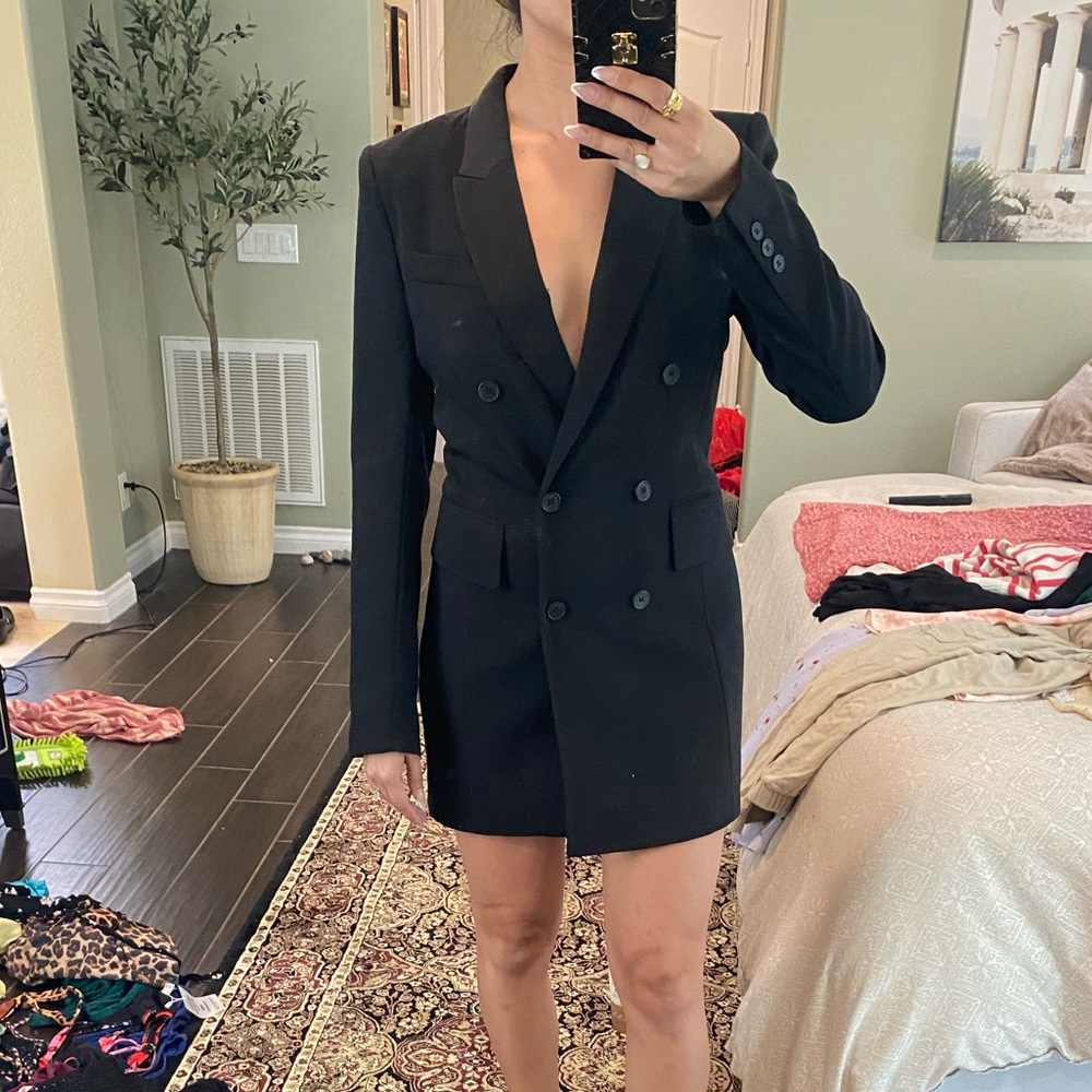 Black blazer dress with shoulder pads and side pockets